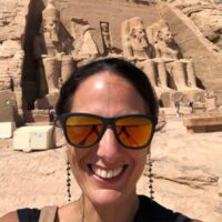 Kirsty Nielsen, the founder of Zen Aroma in front of the sunlit Abu Simbel temples with four colossal statues of Pharaoh Ramses II in the background. About us.
